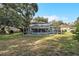 Backyard and pool with a screen enclosure surrounded by mature trees and shrubbery at 709 Grand Canyon Dr, Valrico, FL 33594