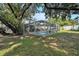 Backyard pool with a screened enclosure as viewed from the rear of the yard at 709 Grand Canyon Dr, Valrico, FL 33594