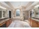 Luxurious primary bathroom with granite countertops, dual sinks, a soaking tub, and a separate glass-enclosed shower at 709 Grand Canyon Dr, Valrico, FL 33594
