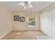Neutral bedroom with a ceiling fan, window with floral pattern valance, and a closet at 709 Grand Canyon Dr, Valrico, FL 33594