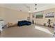 Bonus room featuring a blue sofa, shelves, and a window at 709 Grand Canyon Dr, Valrico, FL 33594