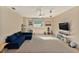 Neutral bonus room with carpet, blue sofa and entertainment center at 709 Grand Canyon Dr, Valrico, FL 33594
