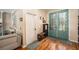Cozy foyer featuring hardwood floors, a white interior door, and decorative blue and green front doors at 709 Grand Canyon Dr, Valrico, FL 33594