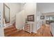Open hallway with hardwood stairs, a mirror, and decorative furniture at 709 Grand Canyon Dr, Valrico, FL 33594