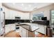 Bright kitchen with white cabinets, granite counters, and an island at 709 Grand Canyon Dr, Valrico, FL 33594