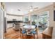Eat-in kitchen featuring white cabinets, black counters, hardwood floors, and sliding door access to the pool at 709 Grand Canyon Dr, Valrico, FL 33594