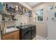 Functional laundry room features a sink, modern washer/dryer, and ample storage shelving for efficient organization at 709 Grand Canyon Dr, Valrico, FL 33594
