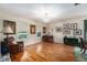 Traditional living room with hardwood floors, a piano, a recliner, and plenty of natural light at 709 Grand Canyon Dr, Valrico, FL 33594