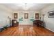 Bright living room with hardwood floors, a piano, accent chair, and views of the front yard at 709 Grand Canyon Dr, Valrico, FL 33594