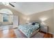 Inviting main bedroom featuring hardwood floors, a king bed, and an ensuite bathroom with a luxurious tub at 709 Grand Canyon Dr, Valrico, FL 33594