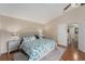 Inviting main bedroom with hardwood floors, vaulted ceiling, king-size bed, and access to the ensuite bathroom at 709 Grand Canyon Dr, Valrico, FL 33594