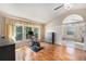 Hardwood-floor main bedroom featuring a peloton bike and ensuite bathroom with a soaking tub and ample natural light at 709 Grand Canyon Dr, Valrico, FL 33594