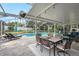 Screened in patio overlooking the pool with dining and lounge seating at 709 Grand Canyon Dr, Valrico, FL 33594