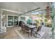 Covered patio area features a tile floor, table with seating for six, and sliding glass doors to the interior at 709 Grand Canyon Dr, Valrico, FL 33594