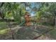 This backyard playground includes a slide, swings, and a charming playhouse for endless fun at 709 Grand Canyon Dr, Valrico, FL 33594