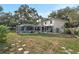 The backyard features a screened-in pool, a covered patio, and ample green space for outdoor activities at 709 Grand Canyon Dr, Valrico, FL 33594