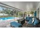 Inviting pool area with a spacious patio, comfortable seating, and a screened enclosure for outdoor enjoyment at 709 Grand Canyon Dr, Valrico, FL 33594