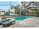 Backyard swimming pool featuring a screened enclosure, poolside lounge chairs, and ample sunshine at 709 Grand Canyon Dr, Valrico, FL 33594