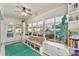 Bright sun room overlooking the pool with large windows, comfortable seating, and built-in shelves at 709 Grand Canyon Dr, Valrico, FL 33594