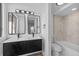 Modern bathroom featuring double sink vanity, stylish mirrors, and bright lighting at 7318 Bellows Falls Ln, Hudson, FL 34667