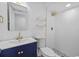 Modern bathroom featuring stylish vanity with gold accents and walk-in shower at 7318 Bellows Falls Ln, Hudson, FL 34667