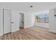 Bright bedroom featuring wood floors, large window, and walk-in closet at 7318 Bellows Falls Ln, Hudson, FL 34667