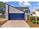 Charming two-story home with a blue garage door and neutral siding at 7318 Bellows Falls Ln, Hudson, FL 34667