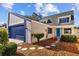 Charming two-story home with a blue garage door and turquoise front door at 7318 Bellows Falls Ln, Hudson, FL 34667