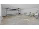Spacious garage with a cement floor and a white garage door at 7318 Bellows Falls Ln, Hudson, FL 34667