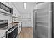 Modern kitchen with stainless steel appliances and white cabinetry at 7318 Bellows Falls Ln, Hudson, FL 34667