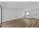 Bright living room featuring wood-look flooring and sliding glass doors at 7318 Bellows Falls Ln, Hudson, FL 34667