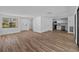 Open-concept living room with wood-look floors leading to kitchen at 7318 Bellows Falls Ln, Hudson, FL 34667