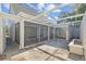 Enclosed patio with sliding glass doors and a stone tile floor at 7318 Bellows Falls Ln, Hudson, FL 34667