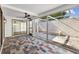 Enclosed patio with decorative tiles and a ceiling fan, offering a cozy outdoor space at 7318 Bellows Falls Ln, Hudson, FL 34667