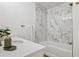 Luxurious bathroom with marble tile, soaking tub, and gold fixtures adding an elegant touch at 800 S Dakota Ave # 204, Tampa, FL 33606