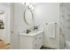 Stylish bathroom featuring a modern vanity, round mirror, and a marble-tiled shower at 800 S Dakota Ave # 204, Tampa, FL 33606