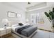 Bright bedroom with hardwood floors, modern ceiling fan, and large window at 800 S Dakota Ave # 204, Tampa, FL 33606