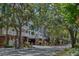 Beautiful condominium complex with mature trees, brick accents, and covered parking at 800 S Dakota Ave # 204, Tampa, FL 33606