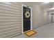 Condominium front door with wreath and neutral colored siding at 800 S Dakota Ave # 204, Tampa, FL 33606
