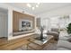 Stylish living room features an accent wall, modern lighting, and wood floors at 800 S Dakota Ave # 204, Tampa, FL 33606