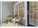 Charming patio seating area with wicker chairs, greenery, and a striped rug at 800 S Dakota Ave # 204, Tampa, FL 33606