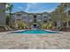 Gorgeous community pool with lounge chairs and lush landscaping offering a resort-like experience at 800 S Dakota Ave # 204, Tampa, FL 33606