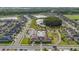 Beautiful aerial view of community, showcasing a pool, clubhouse, playground, and scenic ponds surrounded by lush greenery at 8719 Winning Fields Rd, New Port Richey, FL 34655