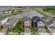 An aerial view of the neighborhood features a pond and well-maintained homes with manicured lawns at 8719 Winning Fields Rd, New Port Richey, FL 34655