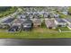 Aerial view of the property features a large yard and a nearby pond at 8719 Winning Fields Rd, New Port Richey, FL 34655