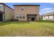 The home has a spacious backyard with a well-kept lawn, perfect for outdoor activities and relaxation at 8719 Winning Fields Rd, New Port Richey, FL 34655