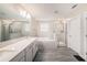 Luxurious bathroom with double vanity, a soaking tub, and separate glass-enclosed shower at 8719 Winning Fields Rd, New Port Richey, FL 34655