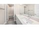 Bright bathroom with double sinks, a large mirror, and a subway-tiled shower-tub combo at 8719 Winning Fields Rd, New Port Richey, FL 34655