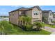 Two-story home featuring well-manicured landscaping and a brick driveway at 8719 Winning Fields Rd, New Port Richey, FL 34655