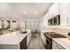 Well-equipped kitchen with stainless steel appliances, a center island, and seamless connection to the living area at 8719 Winning Fields Rd, New Port Richey, FL 34655